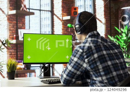 Home office worker using mockup computer, engaging in video call, participating in virtual meeting with colleagues. Man discussing with coworkers during videoconference meeting on green screen PC Home office worker using mockup computer, engaging in video call, participating in virtual meeting with colleagues. Man discussing with coworkers during videoconference meeting on green screen PC 124049296