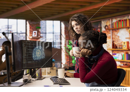 Teamworking technicians coding advanced AI algorithm and machine learning models enhancing automation. Employee talking with coworker in artificial intelligence Silicon Valley workplace Teamworking technicians coding advanced AI algorithm and machine learning models enhancing automation. Employee talking with coworker in artificial intelligence Silicon Valley workplace 124049334