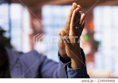 Young remote workers exchanging a high five and feel happy with their success, freelancers celebrating achievement at home. Happy people enjoying productivity and task completion. Close up. 124049466