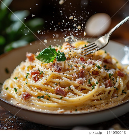 Perfectly cooked spaghetti topped with cheese and herbs in a cozy Italian restaurant setting for a delightful meal experience 124050048