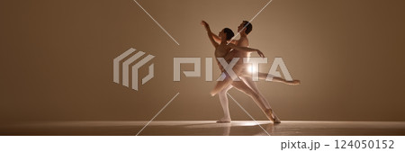 Banner. Ballet duet entwined in expressive pose, intimacy and strength captured in warm glow, feet on pointe, bodies aligned in motion. 124050152