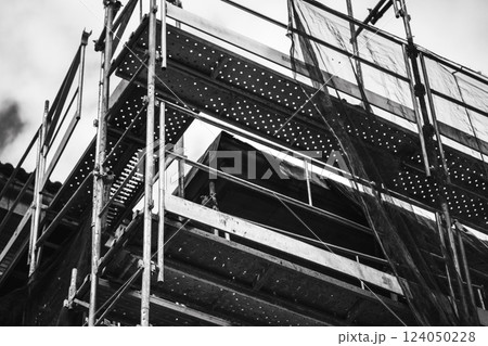 Construction residential buildings black and white. Housing industry. Construction building protective net. Unfinished multistory houses. Real estate. 124050228
