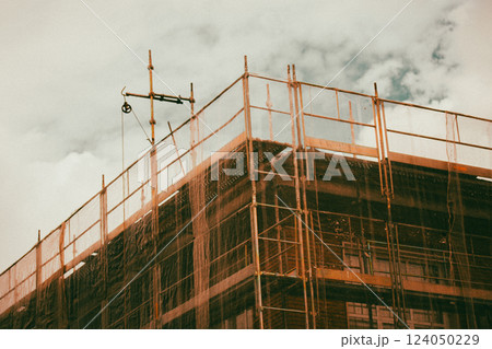 Construction residential buildings corner. Housing industry. Construction building with protective net. Unfinished multistory houses. Real estate. 124050229
