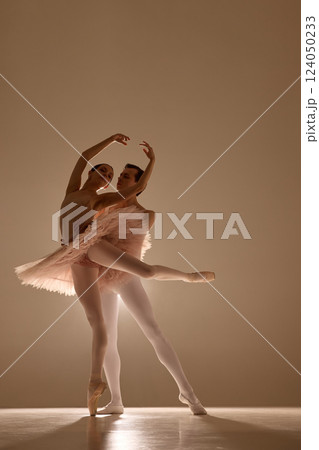 Dynamic photo of ballet duet, man and woman, moves in graceful dance against soft light, highlights their silhouettes. Concept of ballet Dynamic photo of ballet duet, man and woman, moves in graceful dance against soft light, highlights their silhouettes. Concept of ballet 124050233