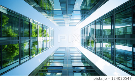 Eco-friendly building in the modern city. Sustainable glass office building with tree for reducing carbon dioxide. Office building with green environment. Corporate building reduce CO2. 124050547