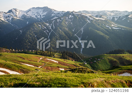 Mountain landscape with blooming plants, sunrise or sunset and valley in the background. Mountain landscape with blooming plants, sunrise or sunset and valley in the background. 124051198