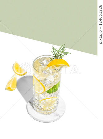 Refreshing mojito with lemon, rosemary and ice in a tall glass on a white green background 124051226