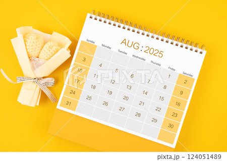 August 2025 desk calendar with bouquet flower on yellow background. 124051489