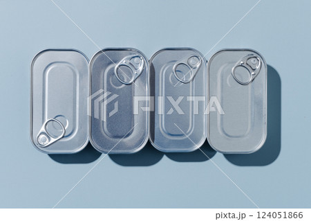 four unopened tin cans of canned food 124051866