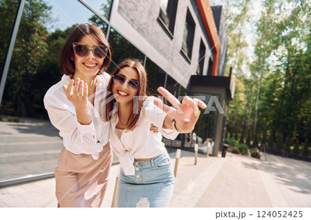 At sunny daytime. Two female friends have great weekend outdoors together 124052425