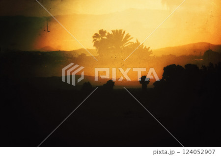 Tropical landscape Mountains, hills on horizon in sunset. Double exposure. Spanish landscapes, wild nature. Palm trees silhouettes. Film filter photo. 124052907