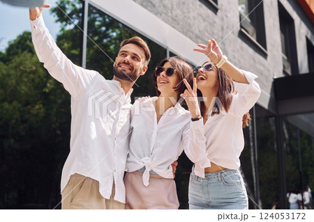 Making a selfie. Three friends having great weekend outdoors together Making a selfie. Three friends having great weekend outdoors together 124053172
