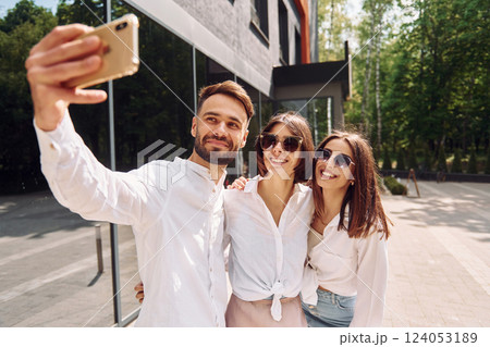 Making a selfie. Three friends having great weekend outdoors together Making a selfie. Three friends having great weekend outdoors together 124053189