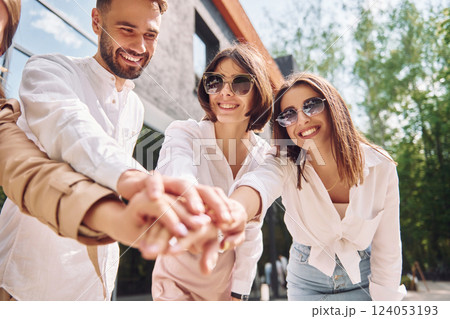 Holding hands together. Conceptin of unity. Three friends having great weekend outdoors together 124053193