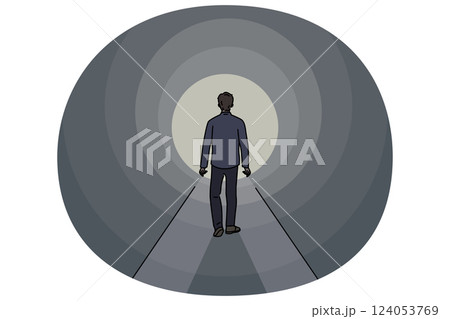 Man walks through tunnel towards exit, striving to achieve success and get out problematic situation 124053769