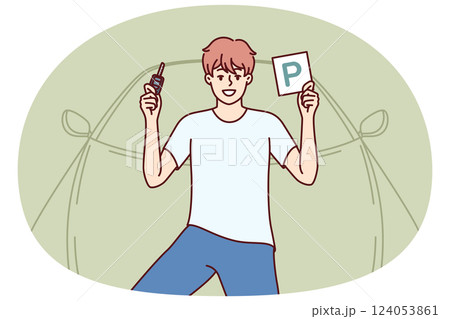 Man driver is standing near car holds key and parking plate after completing training courses 124053861