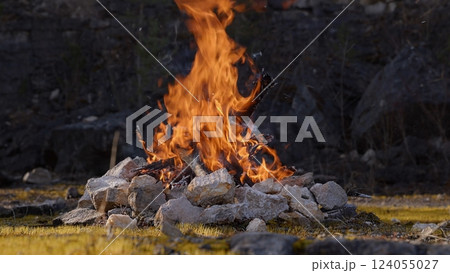 Beautiful Crackling Campfire in a Rocky Landscape , Sunrise , Authentic Place Beautiful Crackling Campfire in a Rocky Landscape , Sunrise , Authentic Place 124055027