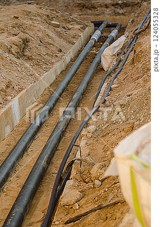 Pipes and Cables Laid in Trench, Construction Site, Underground Utilities. High quality photo 124055328