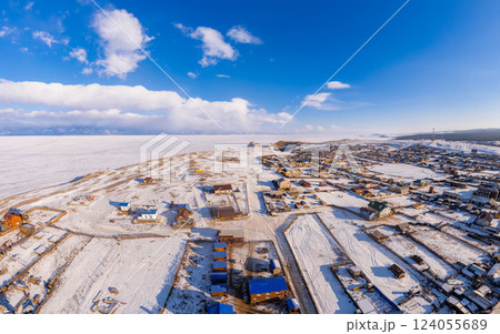 Aerial top view of Khuzhir village largest island of Lake Baikal. Famous Shamanka rock and small sea covered snow. frozen morning winter landscape. Clear ice, Cape Burkhan, Olkhon, Siberia, Russia Aerial top view of Khuzhir village largest island of Lake Baikal. Famous Shamanka rock and small sea covered snow. frozen morning winter landscape. Clear ice, Cape Burkhan, Olkhon, Siberia, Russia 124055689