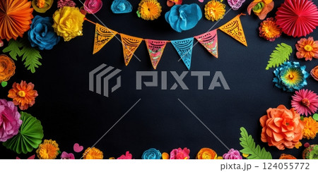 Dark background framed with colorful paper flowers and string of patterned pennants. Festive, handmade decorations create vibrant border with copy space. 124055772