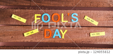 April Fools Day from colored letters, funny notes and paper on wooden top view web banner April Fools Day from colored letters, funny notes and paper on wooden top view web banner 124055812