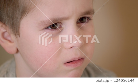 A Thoughtful Child Portrait featuring a captivating and intense expression that draws attention 124056144
