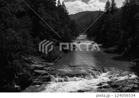 Mountain Stream with Rocky Rapids Flowing Down 124056534