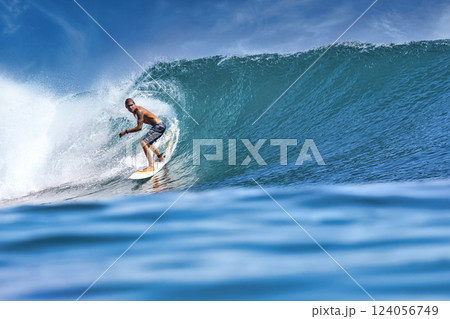 Male surfer on a blue wave 124056749