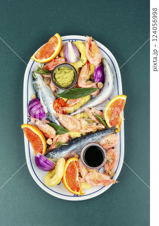 Marinating fresh raw seafood on table, fish delicacy Marinating fresh raw seafood on table, fish delicacy 124056998