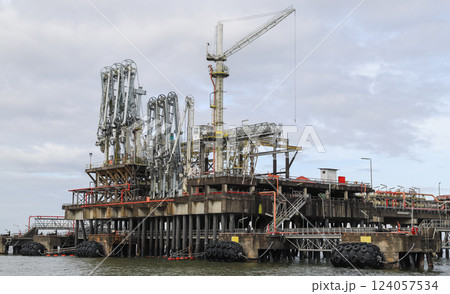 Offshore industrial jetty, close up photo taken from the water on a cloudy day 124057534