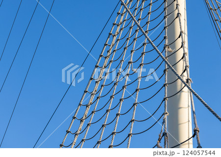 Detailed view of a ships rigging, showcasing its rope lattice Detailed view of a ships rigging, showcasing its rope lattice 124057544