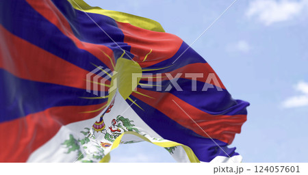 Tibetan flag waving outdoors with snow lions and rising sun symbolizing freedom 124057601