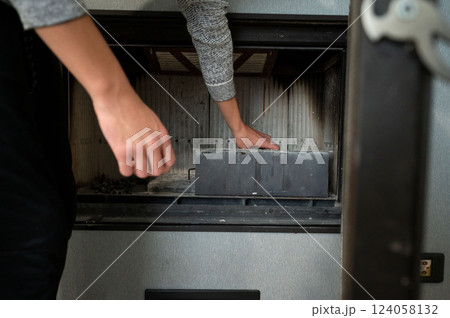 Maintenance routine for a cozy living space with careful cleaning of the fireplace to ensure warmth and safety during chilly evenings spent indoors 124058132