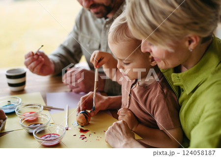 Family decorating easter eggs at home. Family decorating easter eggs at home. 124058187