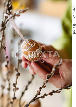 Decorating pussy willows branches with easter eggs. Decorating pussy willows branches with easter eggs. 124058215