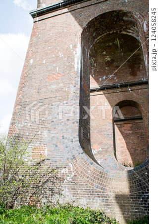 レンガ造りの歴史的な高架橋の楕円形の穴が開いた橋脚　ロンドンから南の郊外にあるオウズ渓谷にて 124058245