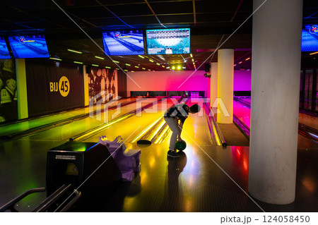 Young boy child having fun and playing bowling 124058450