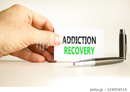 Addiction recovery symbol. Concept words Addiction recovery on beautiful white card. Psychologist hand. Beautiful white paper background. Psychology addiction recovery concept. Copy space. 124058514