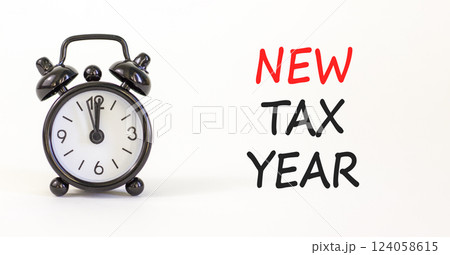 New tax year symbol. Concept words New tax year on beautiful white paper. Beautiful white background. Black alarm clock. Business new tax year concept. Copy space. 124058615