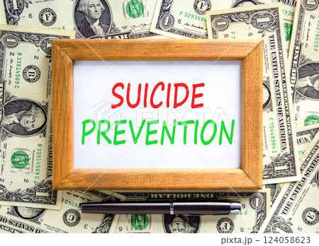 Suicide prevention symbol. Concept words Suicide prevention on beautiful wooden picture frame. Dollar bills. Beautiful background from dollar bills. Psychological suicide prevention concept Copy space Suicide prevention symbol. Concept words Suicide prevention on beautiful wooden picture frame. Dollar bills. Beautiful background from dollar bills. Psychological suicide prevention concept Copy space 124058623
