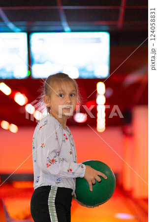 Young girl child having fun and playing bowling 124058831