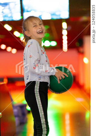 Young girl child having fun and playing bowling 124058835