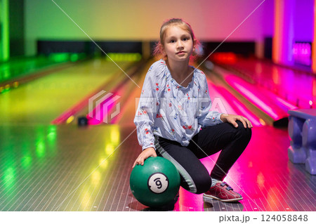 happy young girl having fun cheering while playing bowling game bowling alley happy young girl having fun cheering while playing bowling game bowling alley 124058848