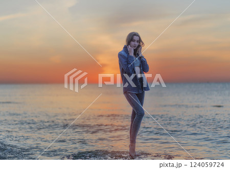 A person standing next to a body of water 124059724