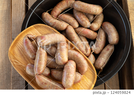 Homemade sausage spread on a wooden and black platter . 124059824