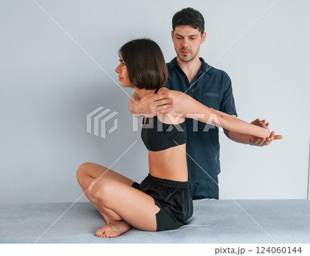 Sitting on the table. Woman visiting physiologist that making massages and helping with traumas 124060144