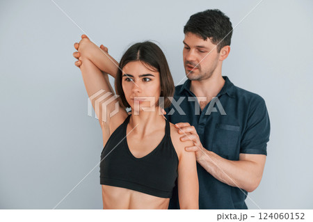 Sitting on the table. Woman visiting physiologist that making massages and helping with traumas 124060152