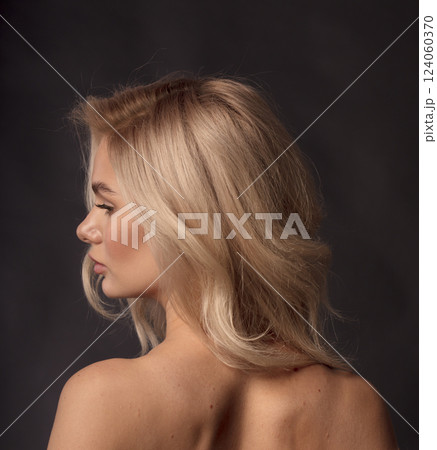 Studio photo portrait of a young pretty blonde on a dark background, close-up portrait of a woman Studio photo portrait of a young pretty blonde on a dark background, close-up portrait of a woman 124060370