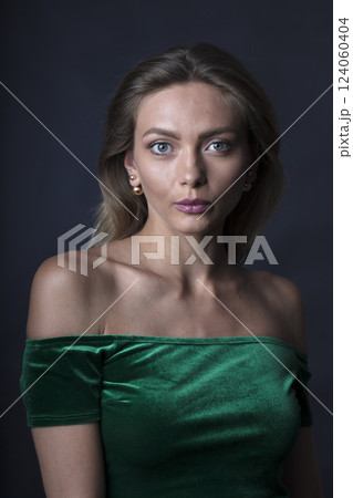 portrait of a young beautiful woman on a dark background 124060404