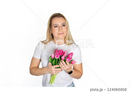 Beautiful blond mature european woman girl in white t-shirt is holding pink purple tulips isolated on white background 124060808
